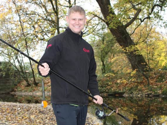 Burnley Leisure staff member Ben Heap trying his hand at fishing in the River Brun in Thompson Park, Burnley