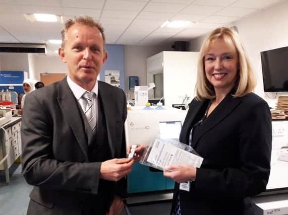 Dr Neil Smith, GP at Oakenhurst Medical Centre, and Dr Kathryn Brownbill, ELHT Clinical Director for Biomedical Science, with the new bowel cancer testing kit and equipment