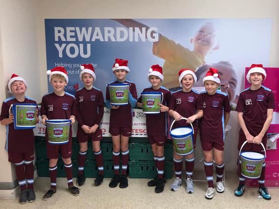 The AFC Clarets football team get ready for their bag packing drive at Tesco in Burnley.