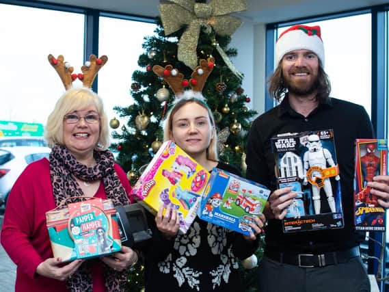Reporter Sue Plunkett (left) with colleagues Laura Longworth, editorial assistant and News Editor John Deehan, with some of the toys donated to our appeal.
