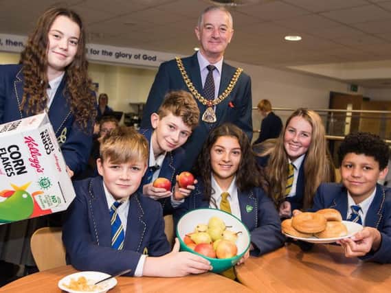 The Mayor of Burnley Coun. Charlie Briggs helps students launch the new breakfast club at Blessed Trinity RC High School.