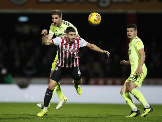 Chris Basham of Sheffield Utd challenges Neal Maupay of Brentford during the Sky Bet Championship match at the Griffin Park Stadium