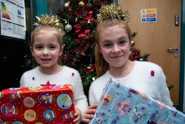 Jolie Forrest (10) and her little sister Trixie, who is four, get ready to hand out gifts to residents at Woodside Home for the Elderly in Padiham.