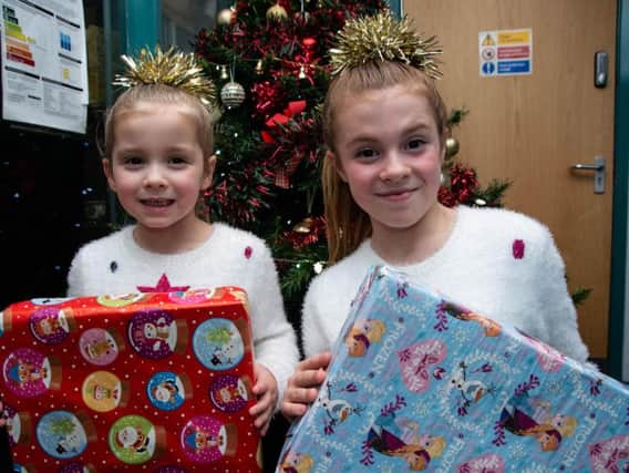 Jolie Forrest (10) and her little sister Trixie, who is four, get ready to hand out gifts to residents at Woodside Home for the Elderly in Padiham.