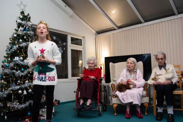Jolie performs her Christmas songs for residents