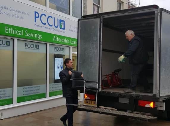 PCCU's David Harris helping to load some of the boardroom furniture