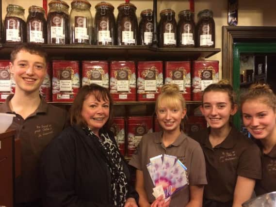 Carol is pictured, second left, surrounded by the staff at Exchange Coffee, Wellgate.