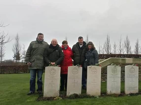The family pay their respects at Arthur's grave in France
