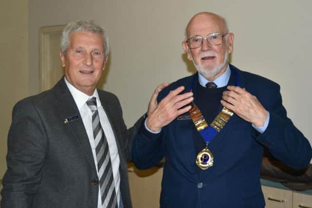 Outgoing president Alan Riley (left) has handed over the chain of office to his successor, Harold Foster.