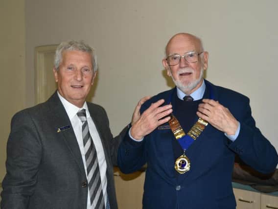 Outgoing president Alan Riley (left) has handed over the chain of office to his successor, Harold Foster.