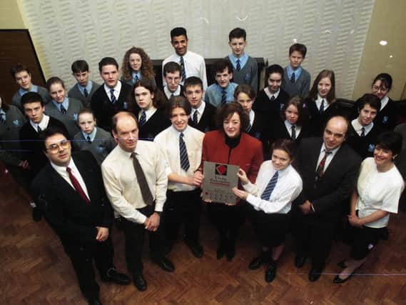 Margaret Malcolm presents a special plaque to Thomas Stadler and Tracey Row of Brownedge St Mary's High School in Bamber Bridge, near Preston, with Phil Murray, Lyell Stott, Martin Walker, Pat Nagle and the Young Enterprise workers. The plaque was presented to reward their efforts during the Young Enterprise scheme