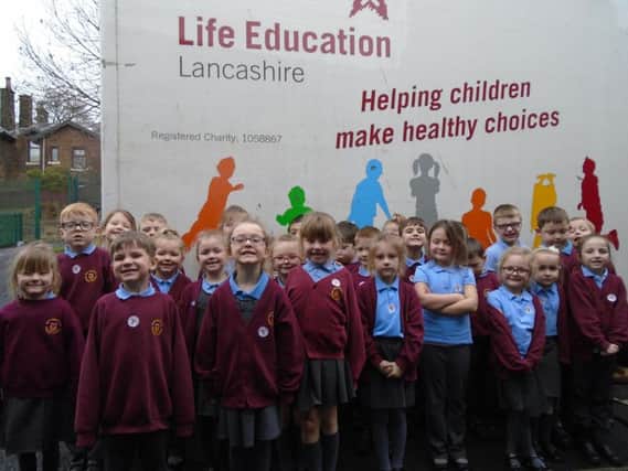 Youngsters from year one at Holy Trinity Primary School in Burnley line up to visit the Life Education Centre bus.