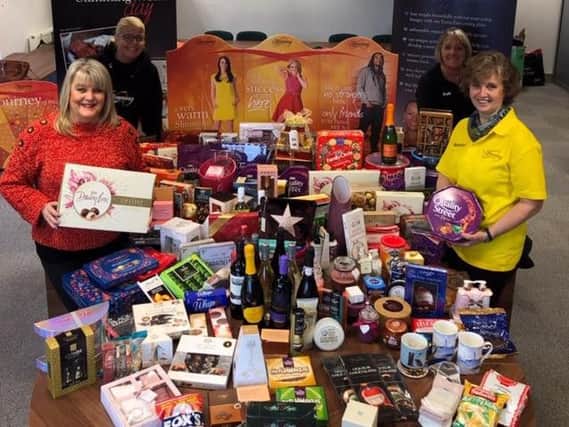 Clockwise are Angela Fielden, Vicky Bradshaw, Janet Barnes and Caroline Griffiths, of Slimming World, with all the donated goodies. (s)