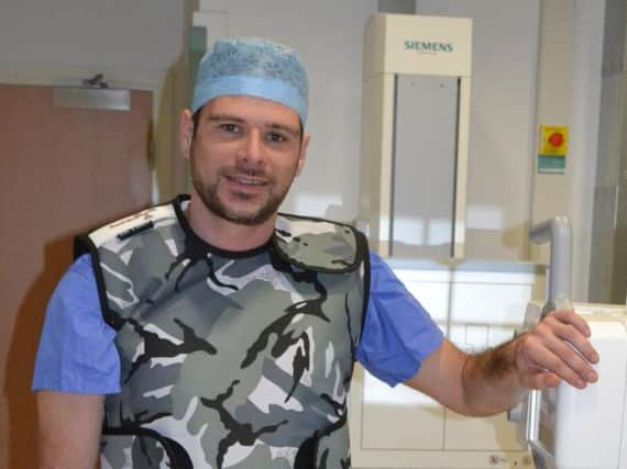 Diagnostic radiologist Adam Wallwork is in training to run the London Marathon wearing a lead vest weighing a stone.