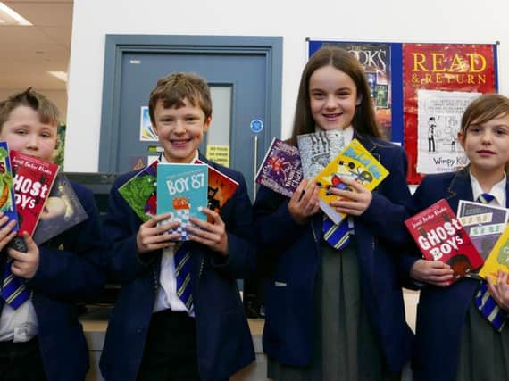 Pupils at Blessed Trinity Roman Catholic College with some of the 40 new books given to the school in a free book pack from the BookTrust. (s)