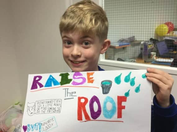 Connor Harrison with his 'Raise the Roof' poster for Burnley Youth Theatre