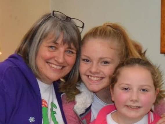 Julie Scott, who has retired after a career spanning 43 years with as a teaching assistant, with her granddaughters, Olivia and Isabelle.