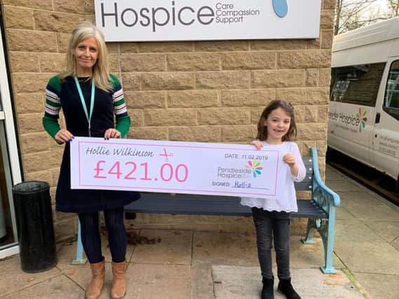 Hollie Wilkinson presents a cheque to the hospice's Jo Applegate