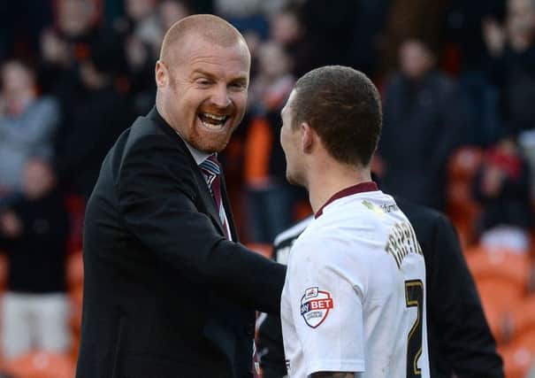 Burnley manager Sean Dyche (left) celebrates with Kieran Trippier after his teams 1-0 win against Blackpool, during the Sky Bet Championship match at Bloomfield Road, Blackpool. PRESS ASSOCIATION Photo. Picture date: Friday April 18, 2014. See PA Story SOCCER Blackpool. Photo credit should read: Martin Rickett/PA Wire. RESTRICTIONS: Editorial use only. Maximum 45 images during a match. No video emulation or promotion as 'live'. No use in games, competitions, merchandise, betting or single club/player services. No use with unofficial audio, video, data, fixtures or club/league logos.