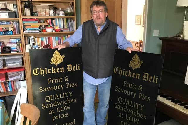 Sam's dad Bill holding the Chicken Deli signs.