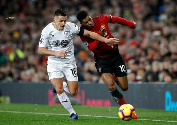 Burnley's Ashley Westwood (left) and Manchester United's Marcus Rashford battle for the ball during the Premier League match at Old Trafford, Manchester. PRESS ASSOCIATION Photo. Picture date: Tuesday January 29, 2019. See PA story SOCCER Man Utd. Photo credit should read: Martin Rickett/PA Wire. RESTRICTIONS: EDITORIAL USE ONLY No use with unauthorised audio, video, data, fixture lists, club/league logos or "live" services. Online in-match use limited to 120 images, no video emulation. No use in betting, games or single club/league/player publications