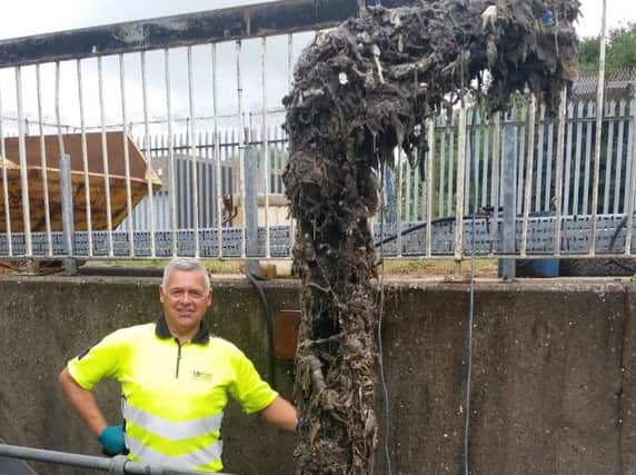 A UU engineer with a congealed mass of wet wipes plucked from the sewers.