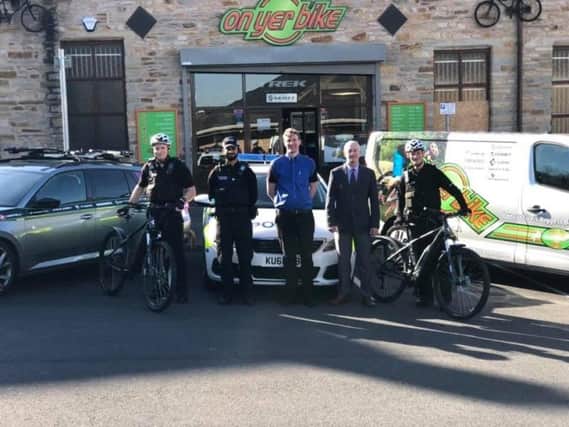 Burnley and Padiham police officers receive their e-bikes from On Yer Bike and the Mayor of Burnley Coun. Charlie Briggs.