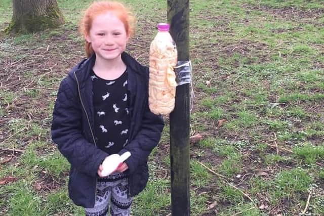 One of the children with her own dog poo bag holder.