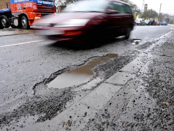 Utility companies could be held accountable for potholes