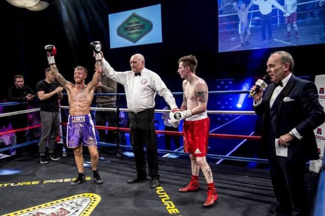 Sam Larkin has his arm held aloft to confirm victory on his debut professional fight				Pictures: Kevin Gilbo\Eat Sleep Boxing Repeat