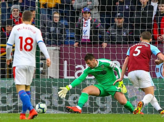 Burnley's Tom Heaton can't stop the shot from Crystal Palace's Wilfried Zaha.