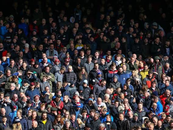 Burnley fans cheer on their side at Anfield. Photo: Alex Dodd/CameraSport