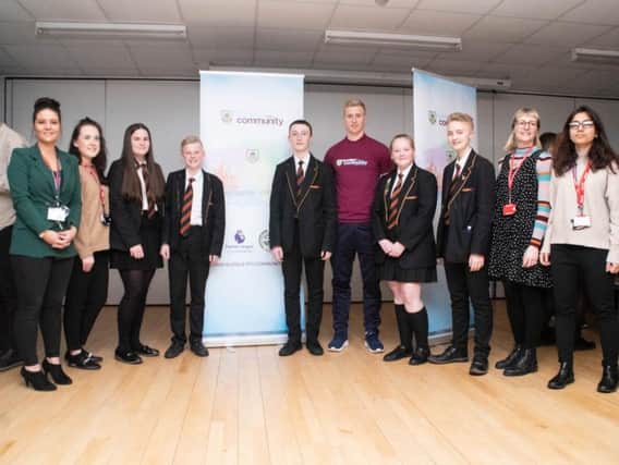 Burnley defender Ben Mee (centre) with students and some of the project's PWPs.