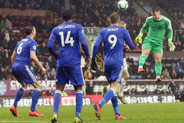 Tom Heaton wins a late header in the Leicester box
