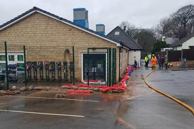 Fire crews, local residents, parents and even schoolchildren gathered to help Barrow Primary School from flooding