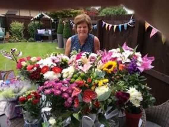 Mrs Janet Ennis with flowers she had received from staff and pupils on her final day at Padiham Green