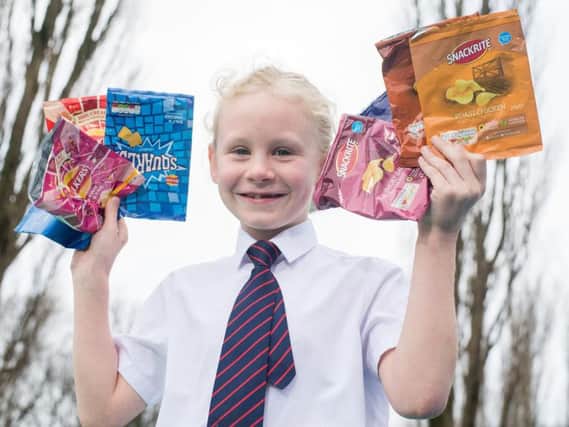 Jessica Gizon with a selection of the crisp packets she and fellow pupils at St Augustine's RC Primary School in Burnley are collecting for recycling.