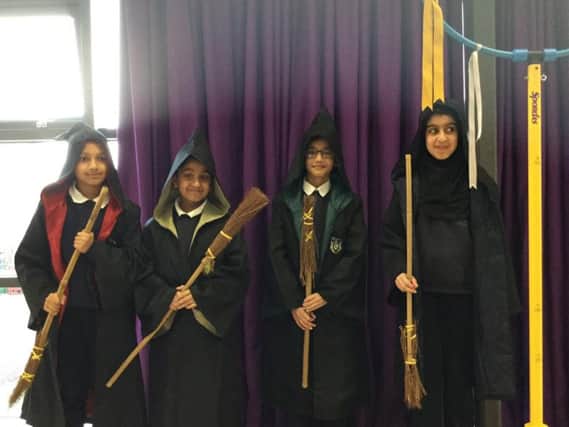 The Reedley students in their cloaks and with their broomsticks.
