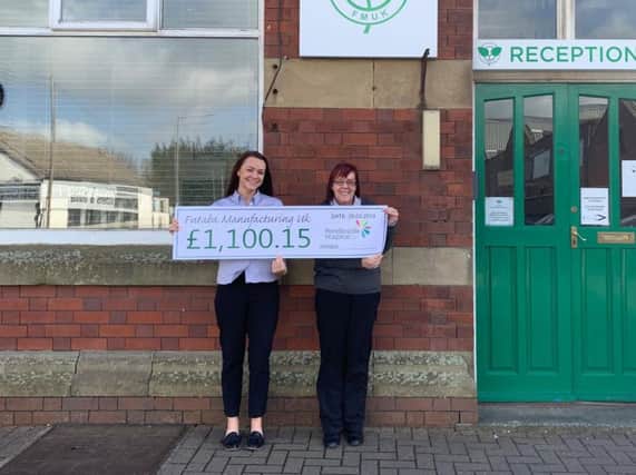 Futaba-Tennecohanded over a cheque for 1,100.15 to Pendleside Hospice