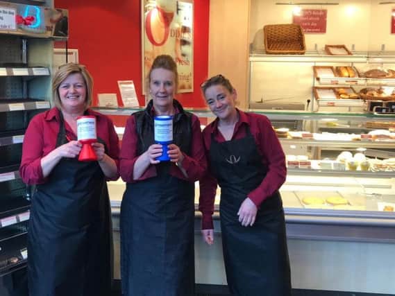 Oddie's counter assistants ( from left)  Dawn Grant, Christine Smith and Lisa Tomlinson) at the Padiham Road, Burnley shop with the collection tins.