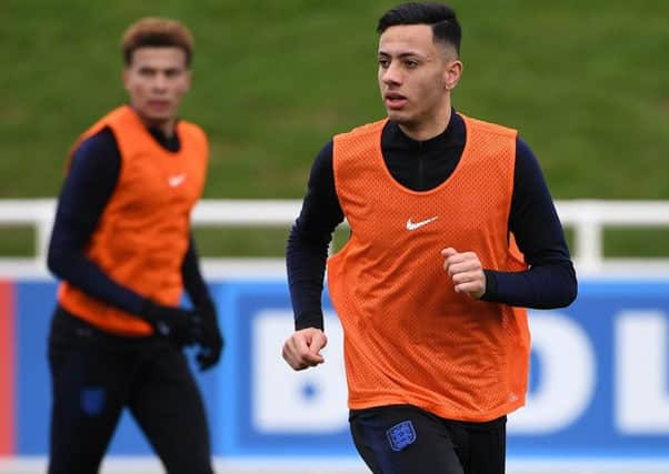 England's midfielder Dele Alli (L) and England's midfielder Dwight McNeil attends a England team training session at St George's Park in Burton-on-Trent, central England on March 19, 2019, ahead of their UEFA EURO 2020 qualifying football matches against the Czech Republic and Montenegro. (Photo by Paul ELLIS / AFP) / NOT FOR MARKETING OR ADVERTISING USE / RESTRICTED TO EDITORIAL USE        (Photo credit should read PAUL ELLIS/AFP/Getty Images)