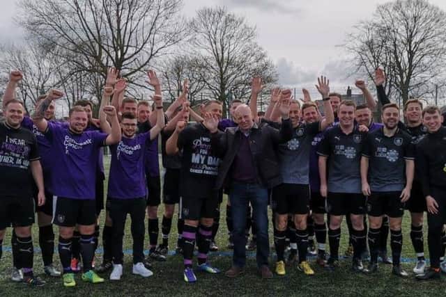 Matt and his dad Paul (centre front) with some of the players at the football tournament that has raised 10,500 for Pancreatic Cancer UK.