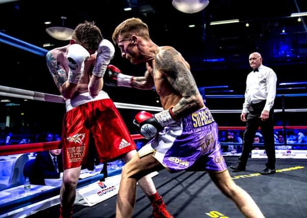 Sam Larkin (purple shorts) in action on his debut against Ricky Leach at Bolton Whites Hotel