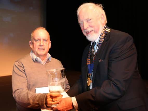 Mike Breeze (right), chairman of Burnley Film-makers, presenting an award at the society's 43rd film festival. (s)