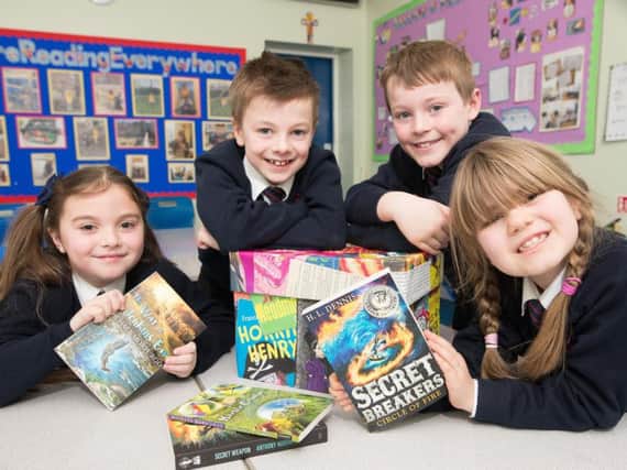 Lola Whittaker, Lewis Sudall, Rory Wilcock and Freya Gracey, students at St Augustine's RC Primary School in Burnley, each scored 100% in a book quiz.