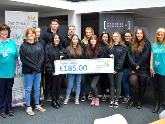 The hard working apprentices from Project Digital hand over a cheque to Pendleside Hospice for the cash they made from their enterprising business idea.