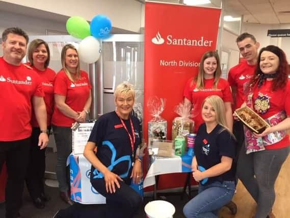 Iain Bissett, Susan Coates, Sara Costelloe, Norma Tinsley and Claire Smith (both kneeling down), Laura Cox, Martin Sansam and Melanie Spedding are the Santander charity denim day. (s)