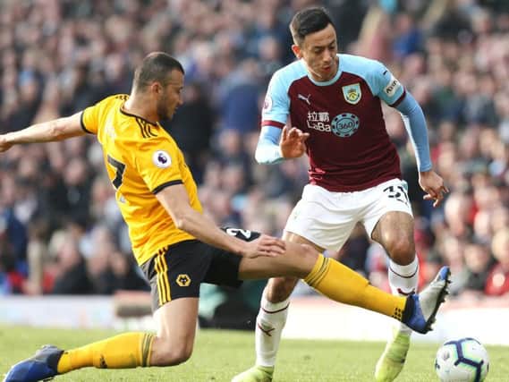 Burnley's Dwight McNeil tries to find a way past Wolverhampton Wanderers' Romain Saiss