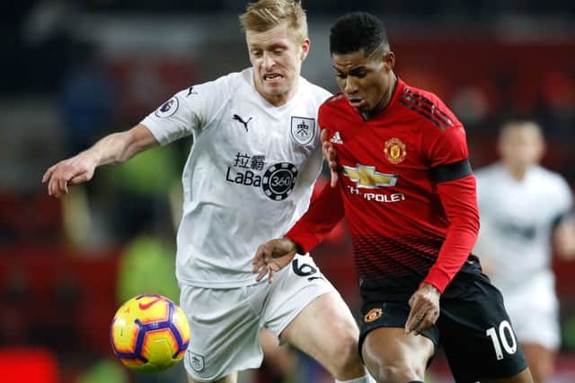Burnley's Ben Mee (left) and Manchester United's Marcus Rashford battle for the ball during the Premier League match at Old Trafford, Manchester. PRESS ASSOCIATION Photo. Picture date: Tuesday January 29, 2019. See PA story SOCCER Man Utd. Photo credit should read: Martin Rickett/PA Wire. RESTRICTIONS: EDITORIAL USE ONLY No use with unauthorised audio, video, data, fixture lists, club/league logos or "live" services. Online in-match use limited to 120 images, no video emulation. No use in betting, games or single club/league/player publications