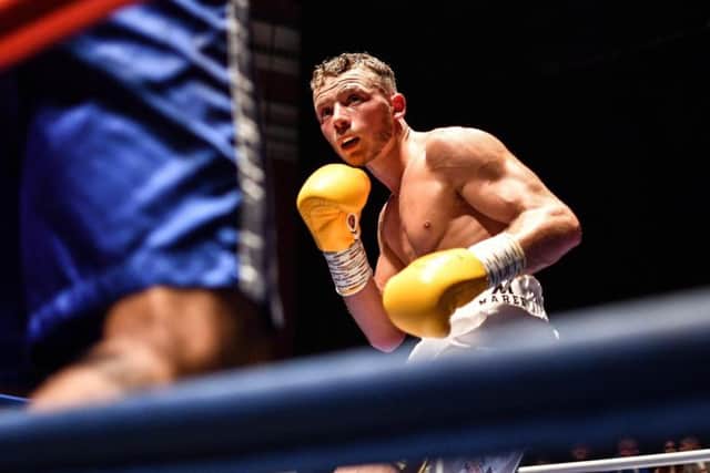Josh Holmes looks for an opening on his professional debut